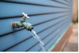 Outdoor faucet on a house exterior